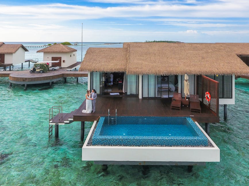Romantic couple on a luxury overwater bungalow deck with infinity pool and ocean view in Hawaii