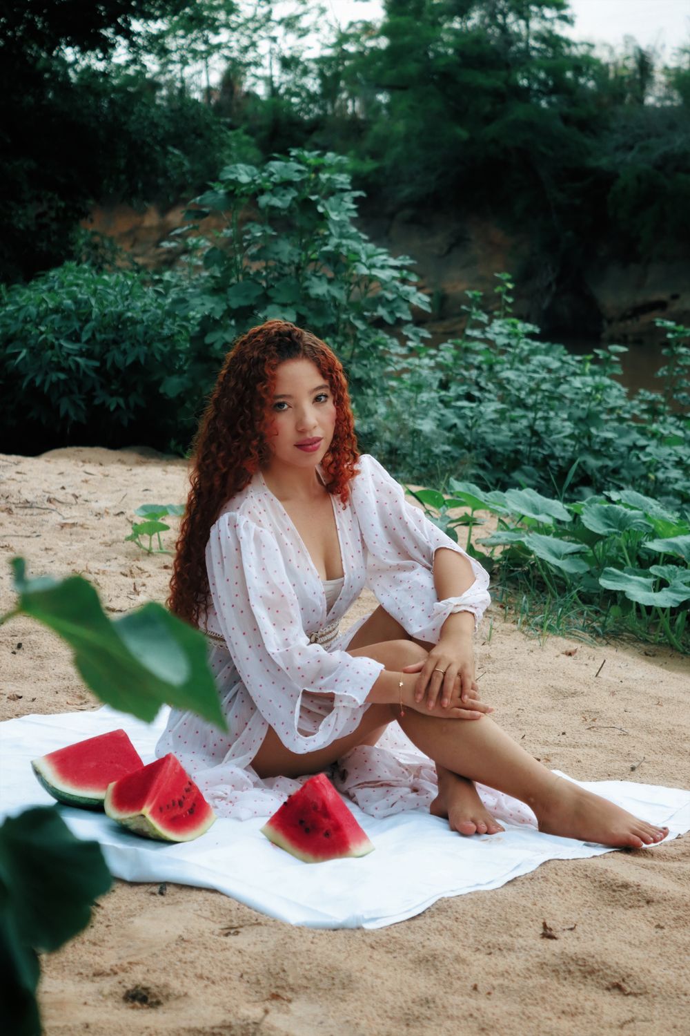 Woman in White Dress Sitting on Brown Sand Near Body of Water · Free ...