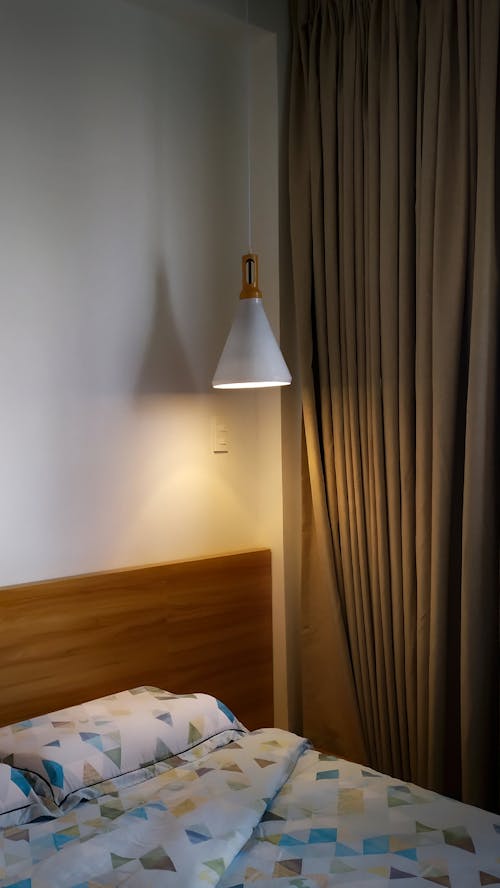 White Hanging Light Near Brown Curtain