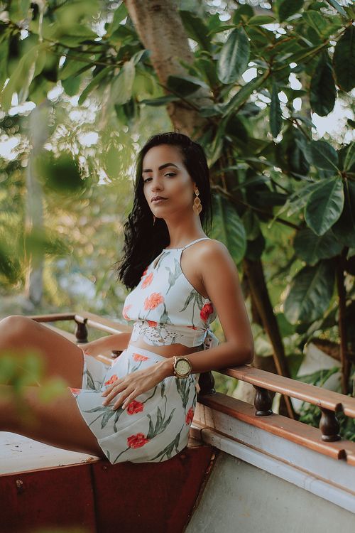Free Young woman in floral dress posing outdoors in Brazil's lush greenery. Stock Photo