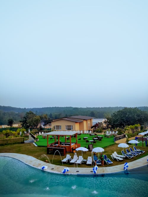 Aerial View of Sun Loungers next to a Swimming Pool at Kushal Palli Resorts in Ajodhya, India 