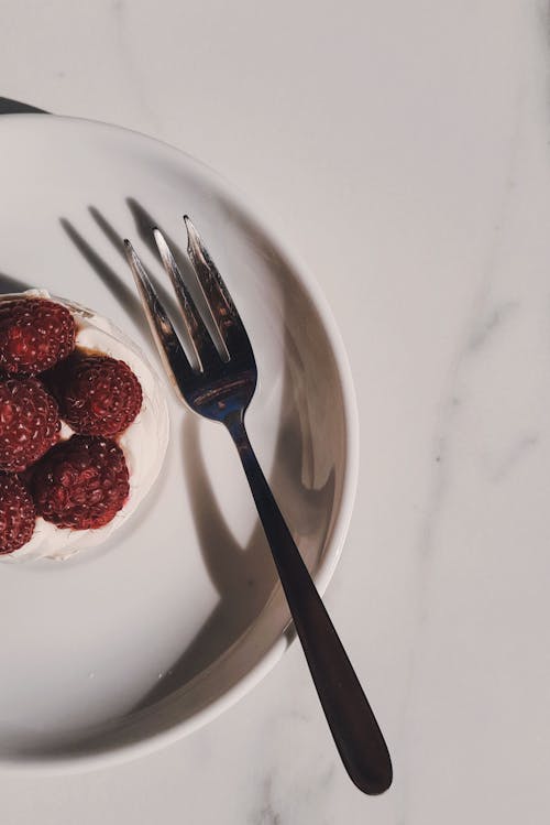 Top View Photo of Raspberries near Fork