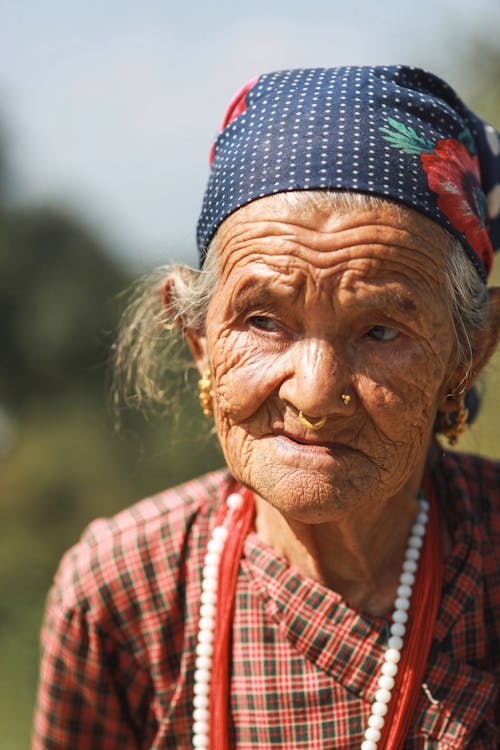 Close-Up Photo of Elderly Woman wearing Blue Headscarf