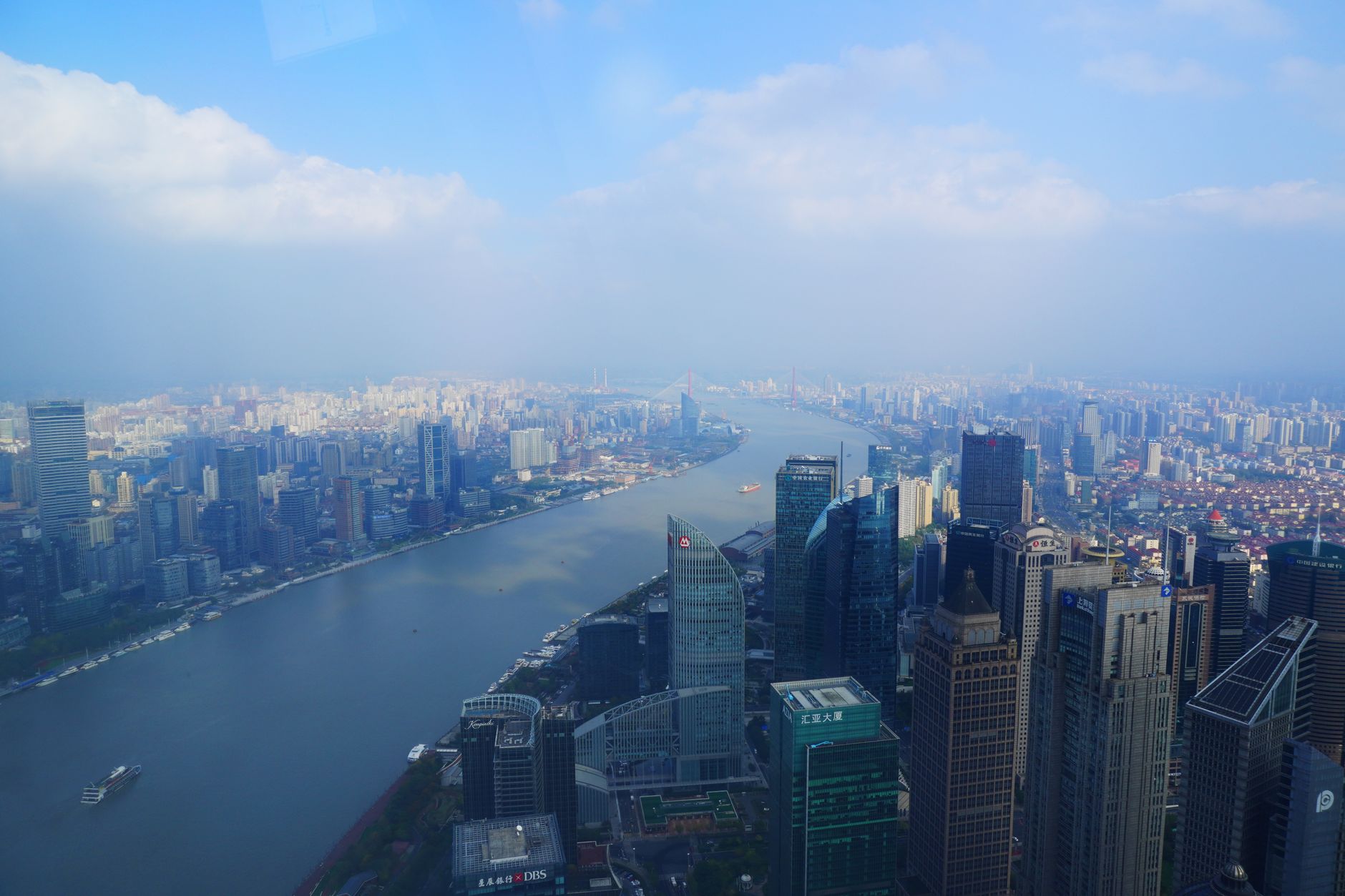 A breathtaking aerial cityscape of Shanghai, China, featuring skyscrapers along the Huangpu River.