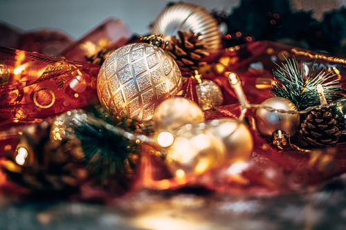 Free A cozy close-up of sparkling Christmas ornaments and warm golden lights, perfect for festive decor inspiration. Stock Photo