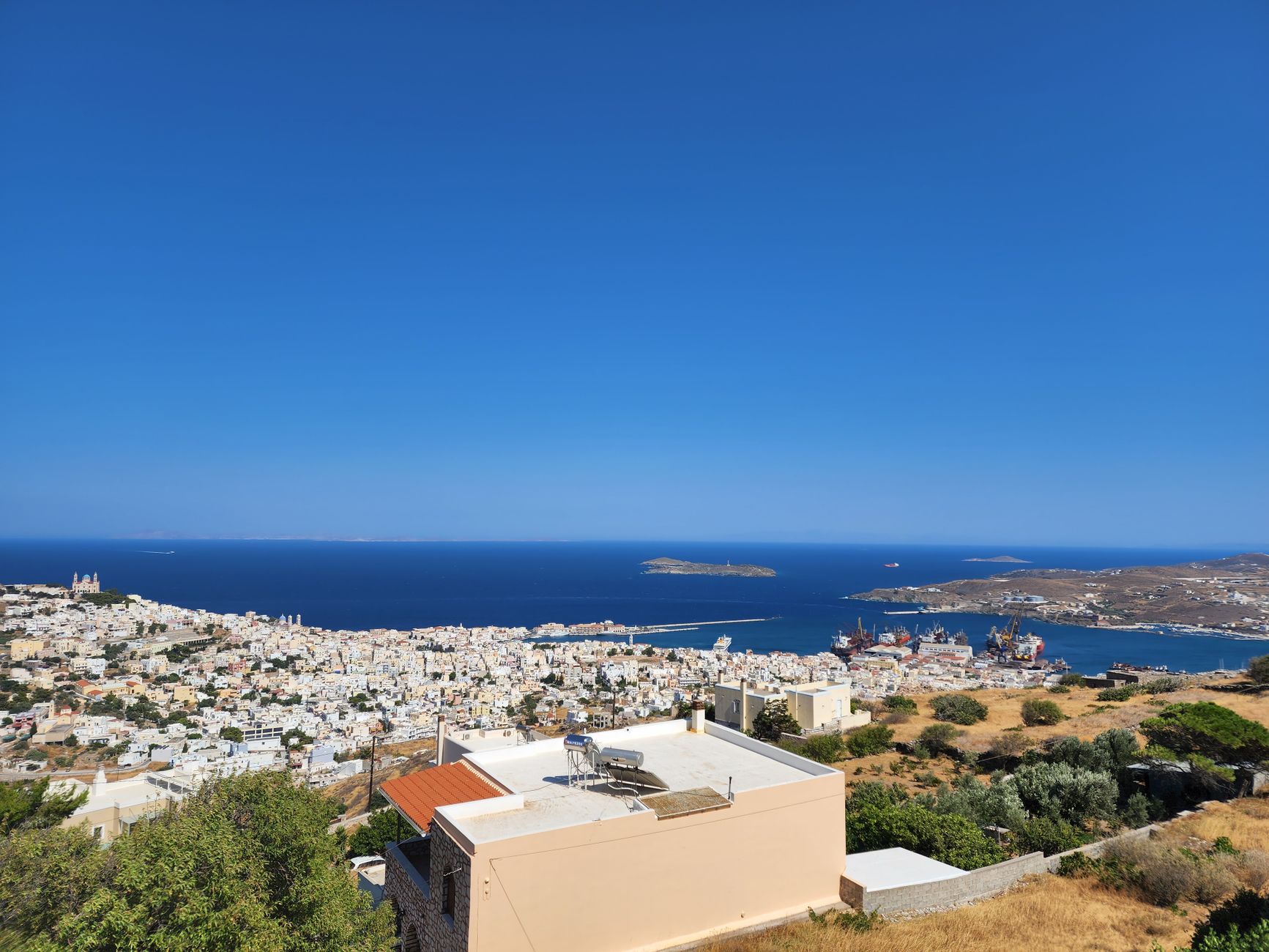 Aerial view of Ermoupoli on Syros, its tiled roofs and harbour on the Aegean.