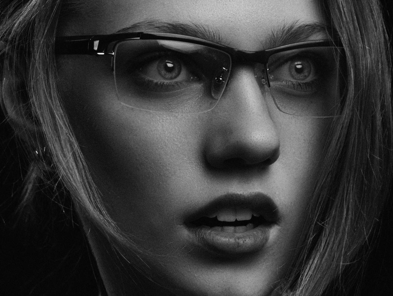 black and white close up portrait of a woman wearing eyeglasses