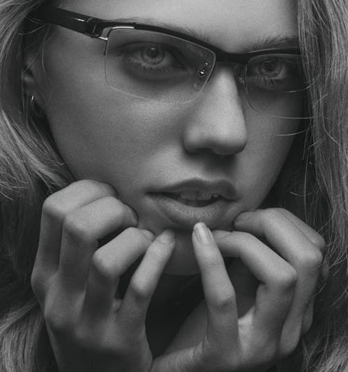 Grayscale Photo of a Woman Wearing Eyeglasses