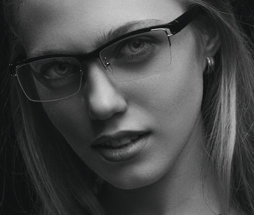 Grayscale Photo of Woman Wearing Eyeglasses