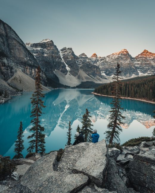 View of Moraine Lake with mountains and pine trees in Banff National Park, Canada.