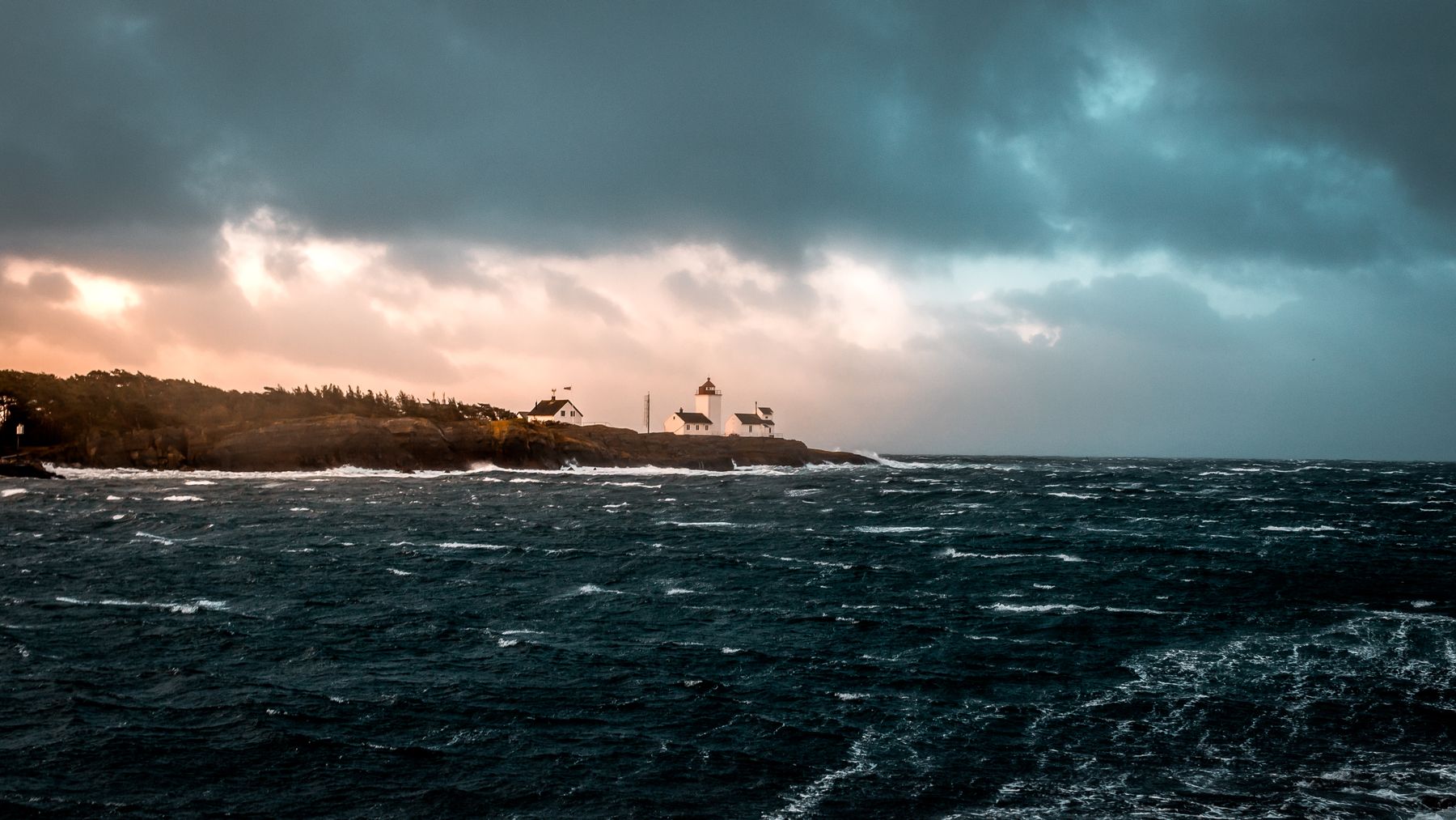 Lanternsea II backdrop: a lighthouse on a rocky island at dusk. Photo by Sindre Fs on Pexels