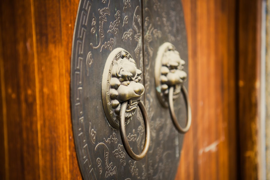 Free Brass Door Knocker on a Wooden Door Stock Photo