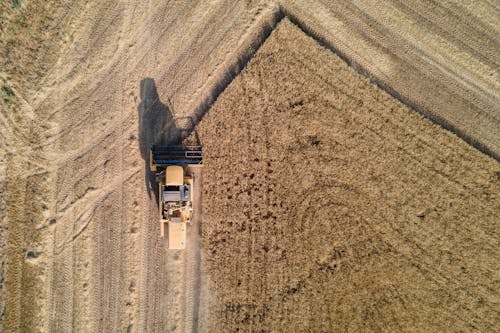 Top View of a Combine Harvester Working in a Field 