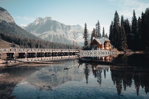 Free Beautiful lodge with bridge and mountains reflecting in Emerald Lake, BC. Stock Photo