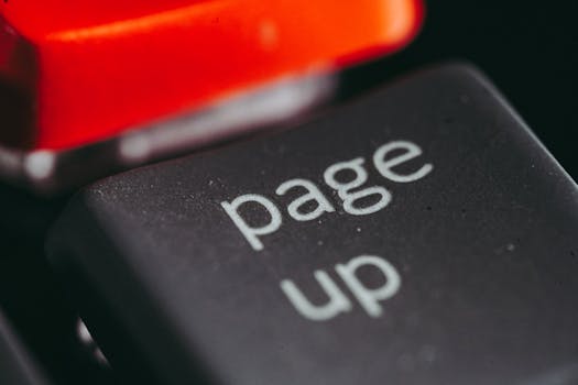 Close-up macro photography of a keyboard's 'page up' key, highlighting its texture and design.