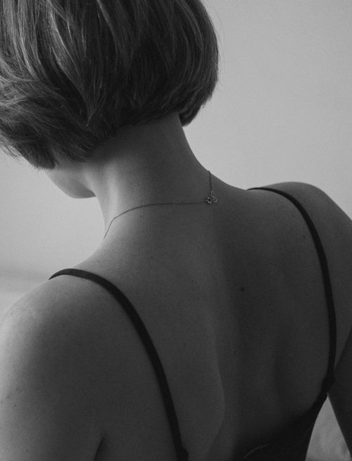 Free Minimalist black and white close-up of a woman's back wearing a necklace. Stock Photo