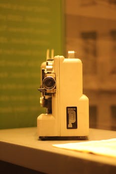 Close-up of a retro film projector in warm lighting, highlighting nostalgic technology.