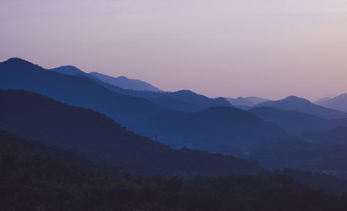 Free Peaceful view of rolling mountains at dusk in Koraput, India, casting a calming blue hue. Stock Photo
