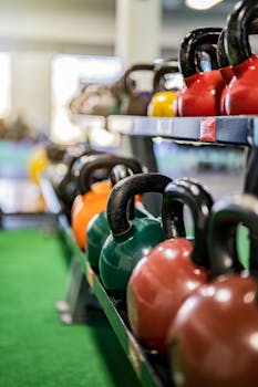 A rack of colorful kettlebells in a gym, symbolizing fitness and strength training.