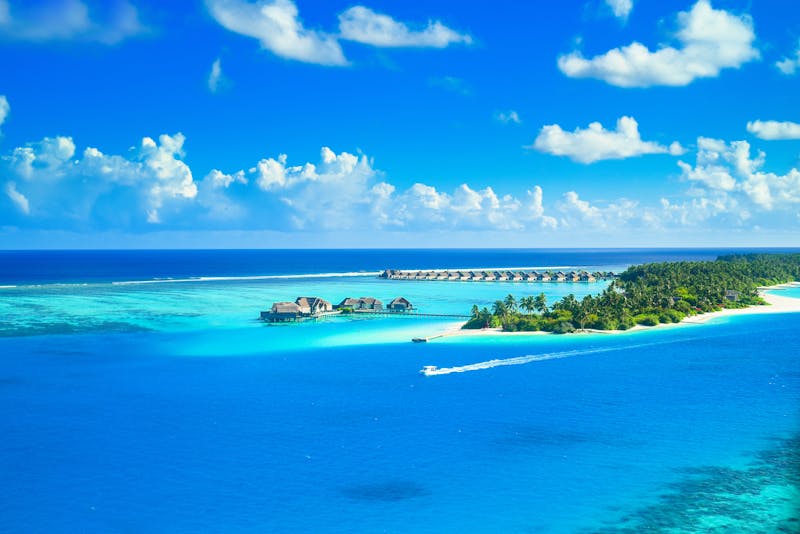 Luxury travel destination with crystal clear waters and overwater bungalows