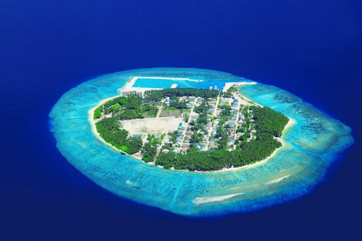 Stunning aerial view of an isolated tropical island surrounded by blue ocean waters.