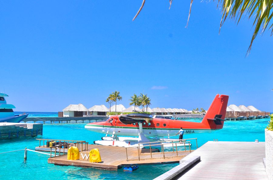 Seaplane landing Maldives turquoise ocean lagoon