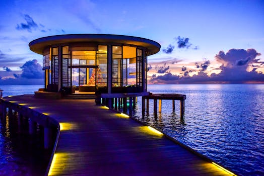 Beautiful round pavilion on a pier overlooking the tranquil sea at sunset.