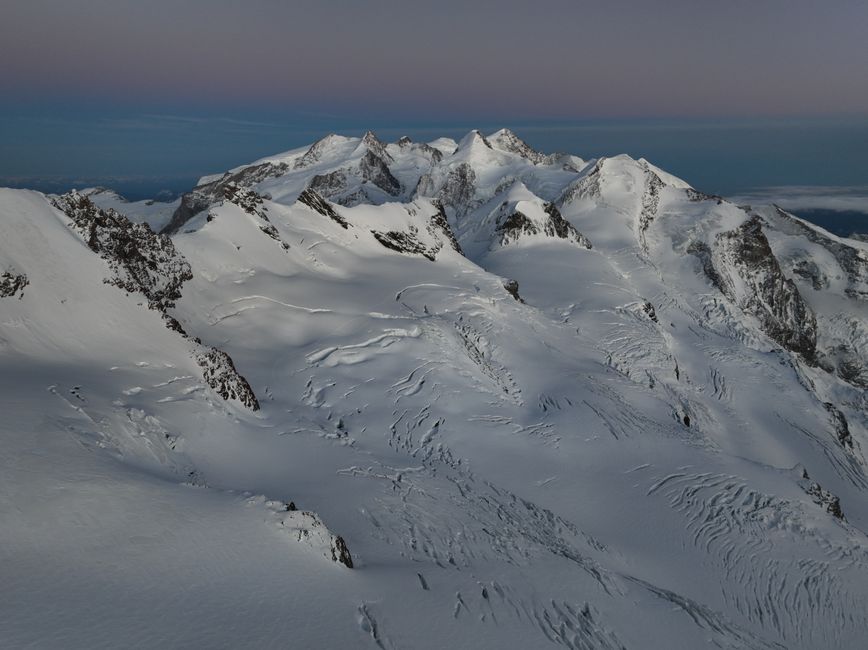 A stunning aerial shot of snow-covered Swiss Alps peaks during winter in Zermatt, Switzerland.