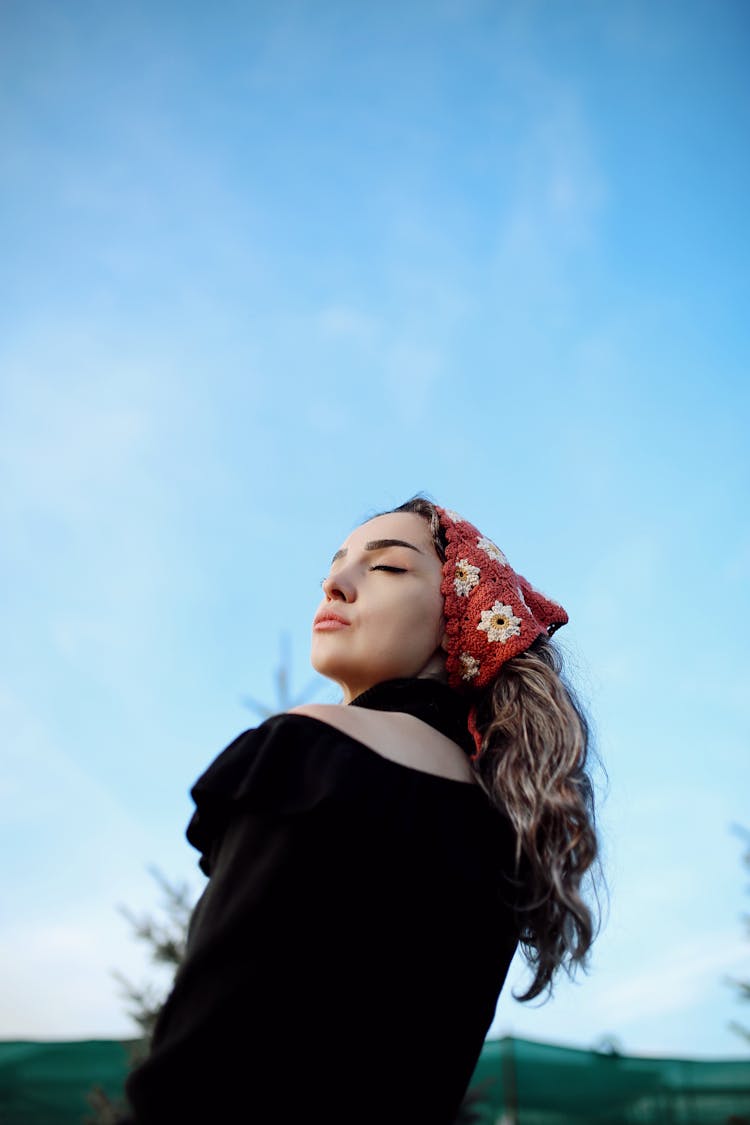 Low-Angle Shot Of A Woman With A Red Headscarf