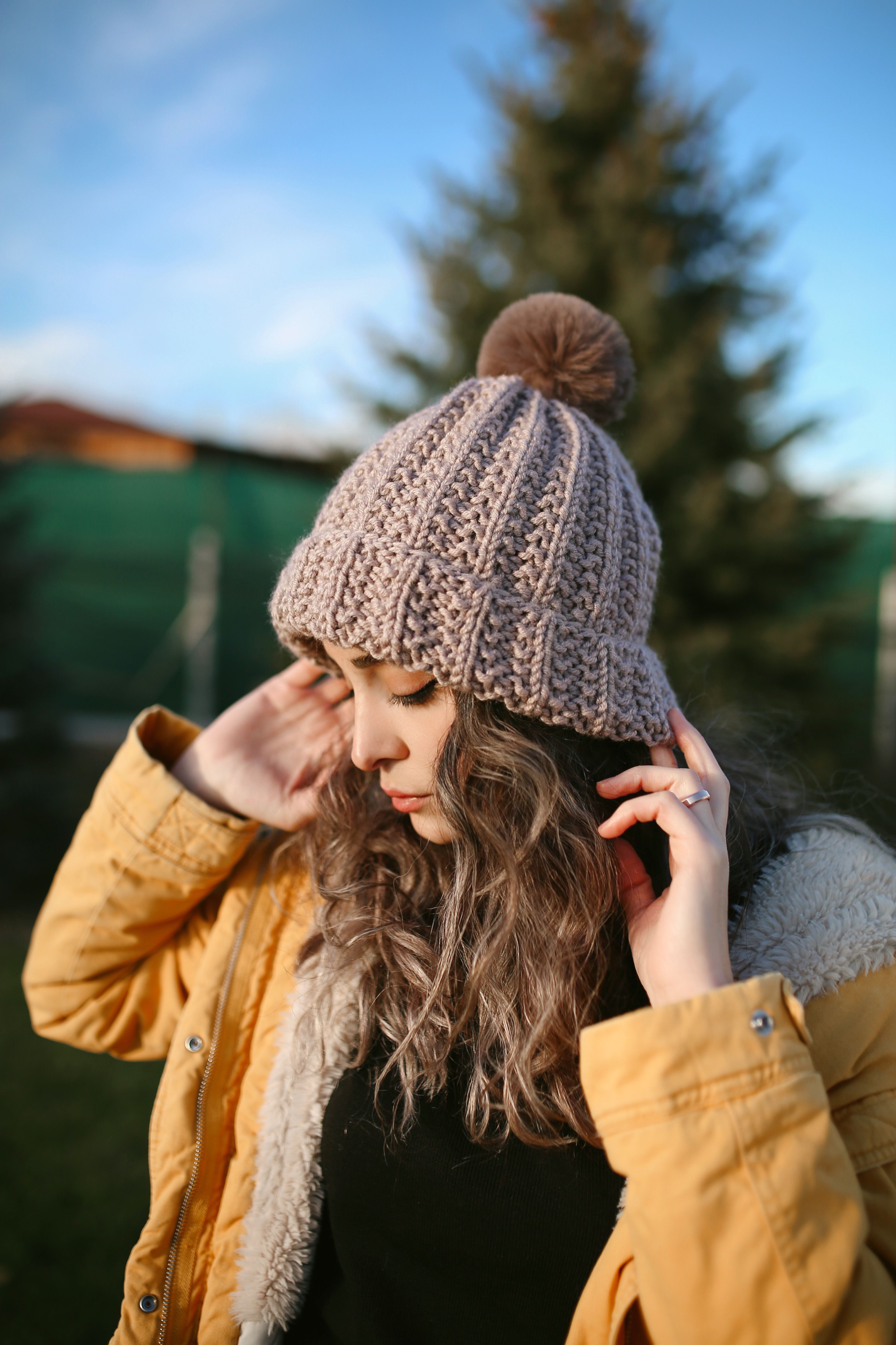 A Woman Sitting while Knitting · Free Stock Photo