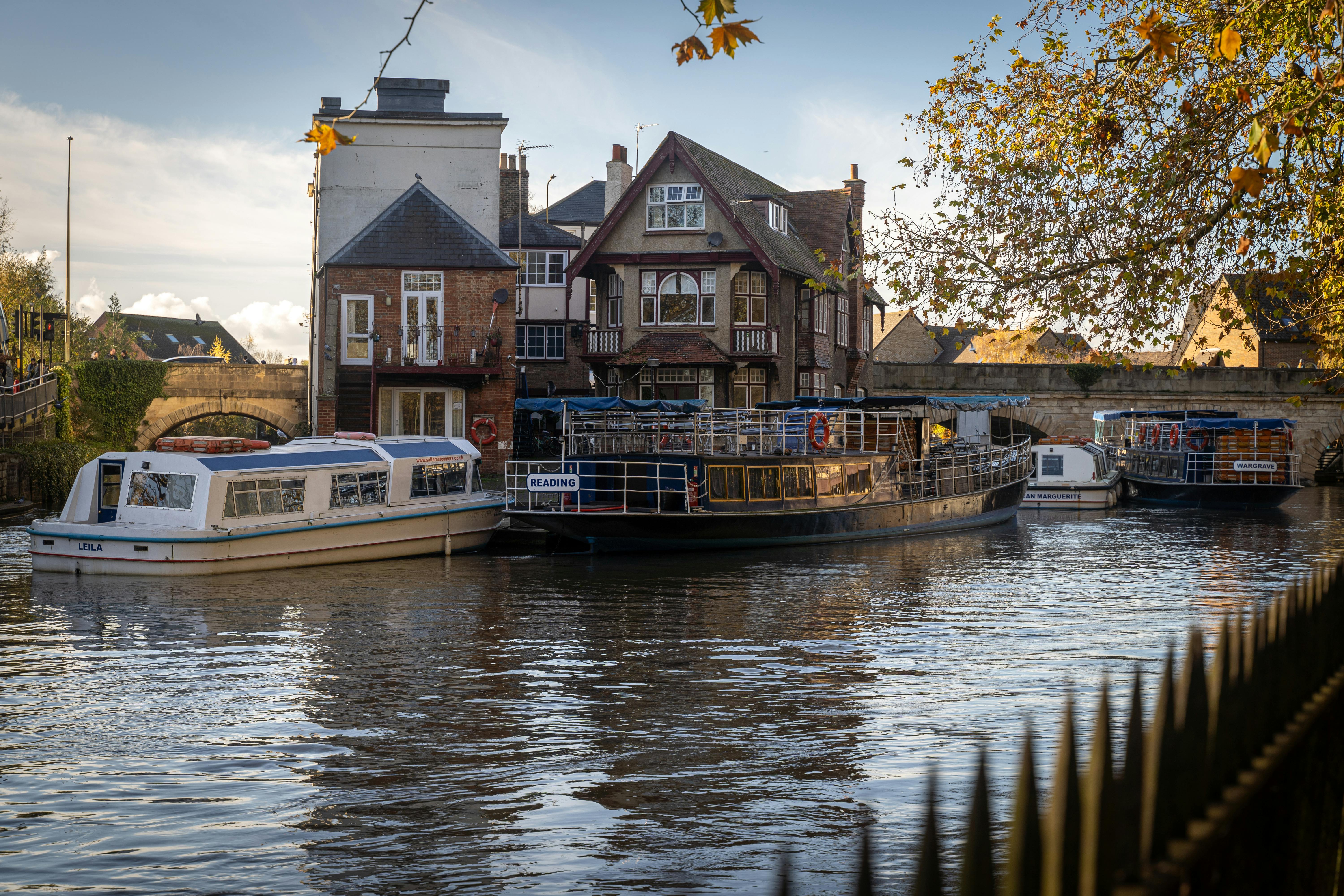 Free Charming boats docked near historic Folly Bridge on a sunny day in Oxford, England. Stock Photo