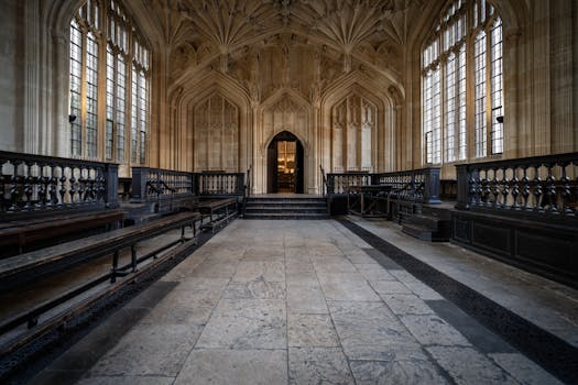 Elegant Gothic interior hallway at Oxford University showcasing symmetrical architecture.