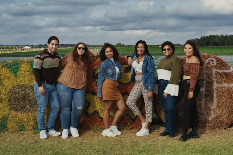 Group Of People Standing Beside Haybales