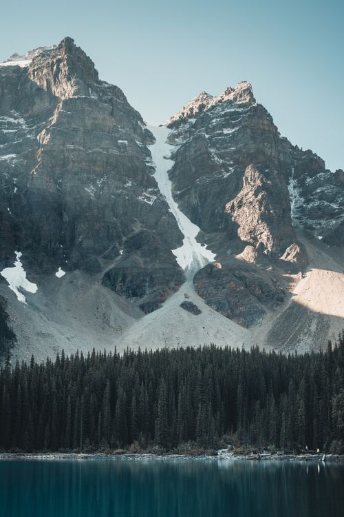 Free Stunning view of the Canadian Rockies with snow-capped peaks reflecting in Moraine Lake. Stock Photo