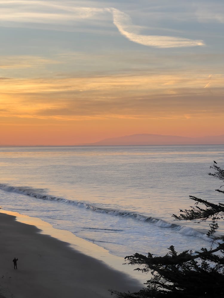 Ocean Waves Rushing To Shore During Sunset