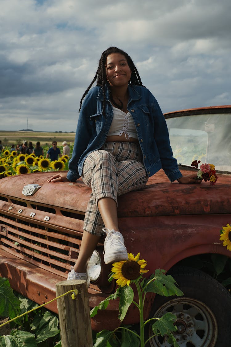 Woman Sitting On A Truck Hood