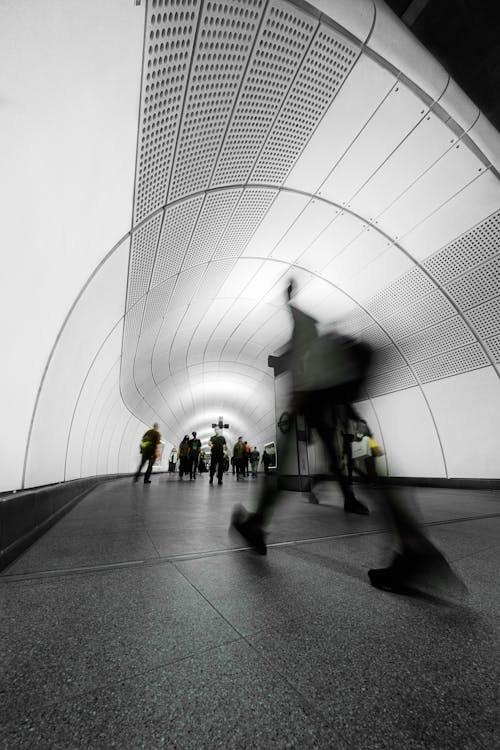 Black and White Photo of a Subway and People in Blurred Motion