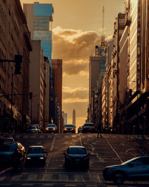 Free Dramatic urban sunset view down Buenos Aires street leading to the Obelisk landmark. Stock Photo
