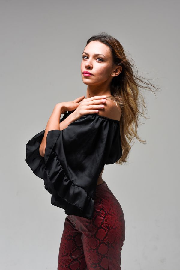 Woman wearing an off-shoulder bodysuit with high-waist trousers