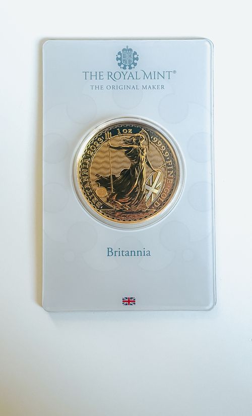 Free Luxurious gold Britannia coin encapsulated by The Royal Mint. A collector's treasure from the UK. Stock Photo