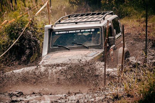 Experience the excitement of an off-road vehicle navigating through muddy trails, showcasing rugged adventure.