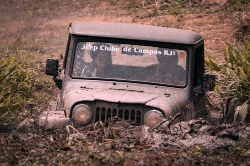 Free Jeep tackling a muddy off-road trail, showcasing adventure and rugged terrain. Stock Photo