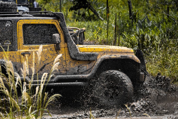 Yellow Jeep On Muddy Terrain