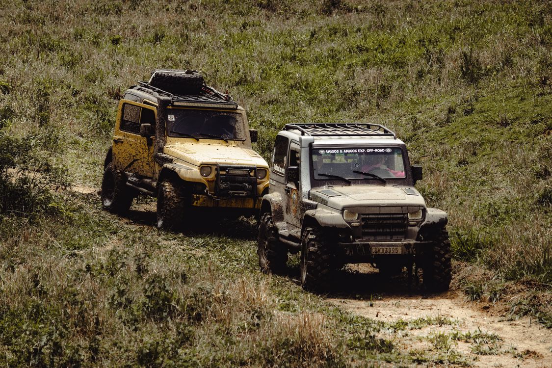 Car For Rough Road Riding Photo of Terrain Cars on a Dirt Road · Free Stock Photo