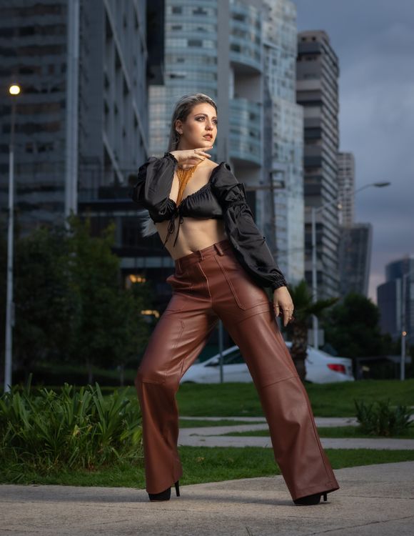 Beautiful Woman in Black Top and Brown Pants Posing on Pavement · Free ...