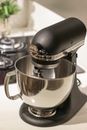 Black and Silver Kitchenaid Stand Mixer on Top of White Surface