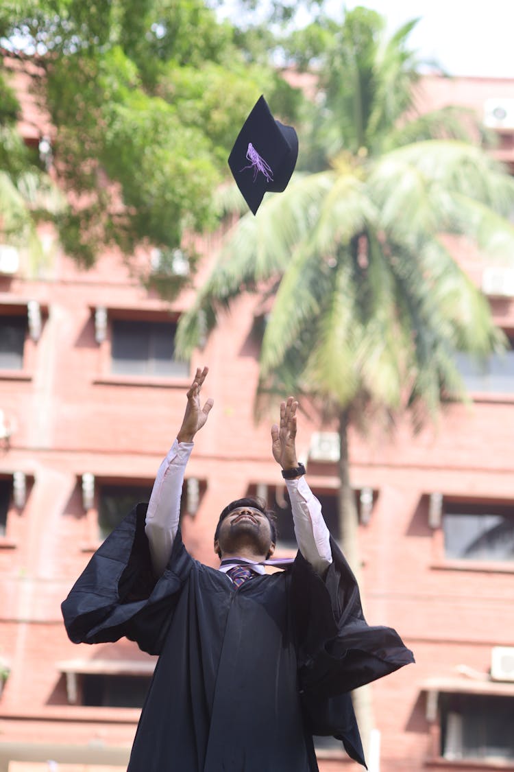 Man Tossing His Mortarboard At Graduation 