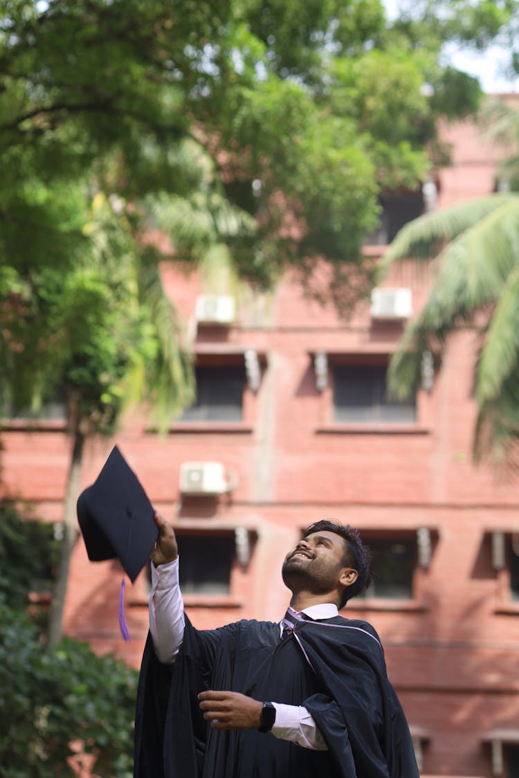 Man Tossing Graduation Cap