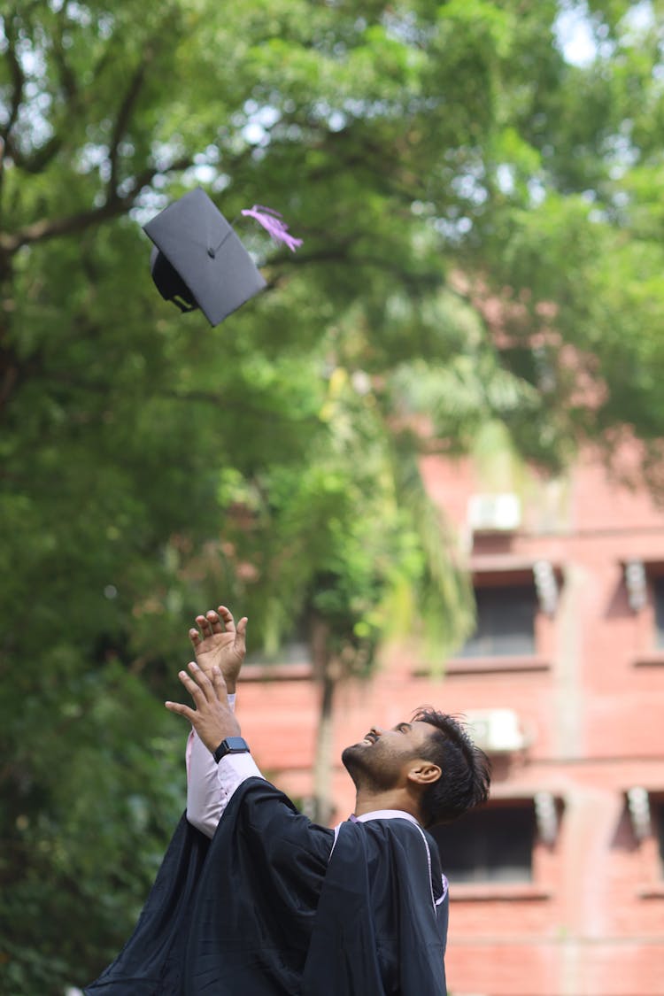 Man Tossing A Mortarboard At Graduation 