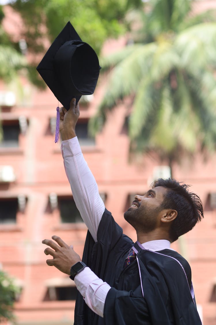 Man Tossing Graduation Cap